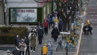 Residents wait in long lines for COVID-19 testing in Beijing this week.