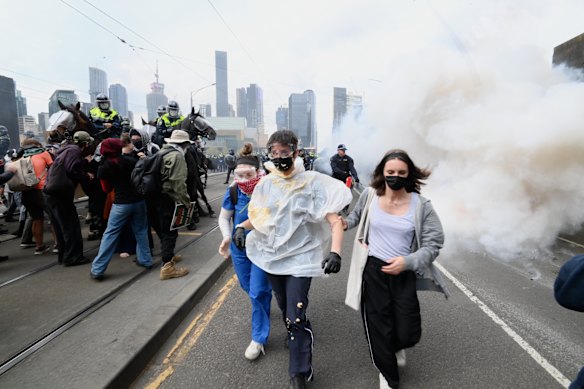 Masked protesters were hit with pepper spray.