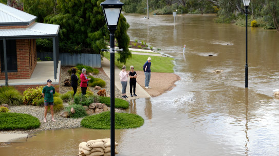 Echuca residents watch the flood roar down Campaspe Esplanade on Sunday.