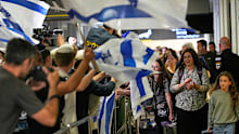 Israeli passengers are welcomed at the arrivals gate at Ben Gurion International Airport.