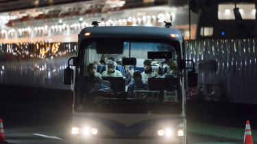 A bus carrying passengers, who will board the Qantas aircraft chartered by the Australian government, from the quarantined Diamond Princess cruise ship drive at the Daikoku Pier in Yokohama, Japan. 