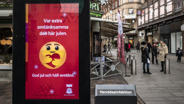 A public information sign wishes Merry Christmas and asks people to maintain social distancing in Helsingborg, southern Sweden.