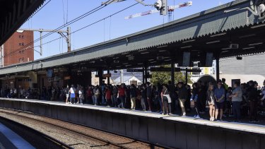 Travellers wait for trains at Strathfield station on Saturday afternoon.