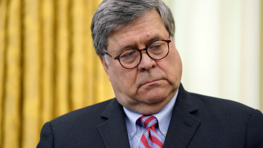 Attorney General William Barr listens as President Donald Trump speaks before signing an executive order aimed at curbing protections for social media giants, in the Oval Office of the White House.