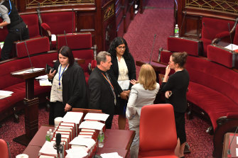 From left, Animal Justice Party MP Andy Meddick, Greens leader Samantha Ratnam, the Reason Party’s Fiona Patten (with her back to the camera) and Labor’s Jaclyn Symes discuss matters in the Victorian upper house.
