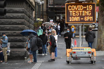 People queue at the COVID-19 testing site at the Melbourne Town Hall on Boxing Day.