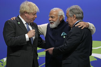 British Prime Minister Boris Johnson, left, and UN Secretary-General Antonio Guterres, right, greet India Prime Minister Narendra Modi at the COP26 UN Climate Summit in Glasgow, Scotland.