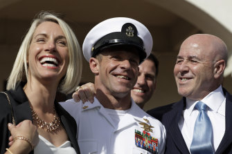 Navy Special Operations Chief Edward Gallagher, centre, leaves court with his wife Andrea, left, in July after being acquitted of murder.