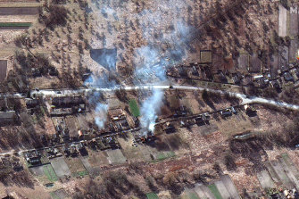 Satellite image showing part of military convoy and burning homes north-west of Invankiv, Ukraine. 