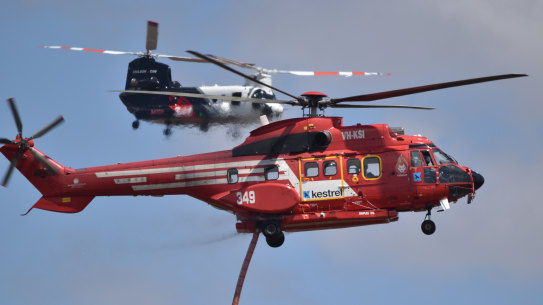 A Kestrel Aviation Super Puma Helitak 349 firebombing helicopter in front of a Coulson Aviation CH-47D Chinook helicopter in Victoria.