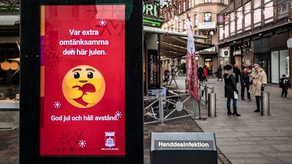 A public information sign wishes Merry Christmas and asks people to maintain social distancing in Helsingborg, southern Sweden.