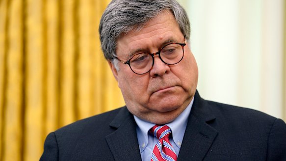 Attorney General William Barr listens as President Donald Trump speaks before signing an executive order aimed at curbing protections for social media giants, in the Oval Office of the White House.