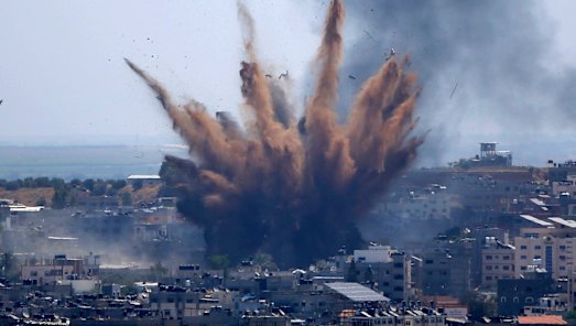 Smoke rises following an Israeli airstrike on a building in Gaza City on Thursday.