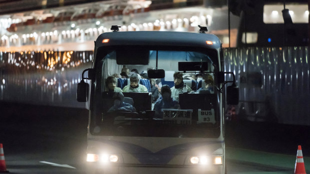 A bus carrying passengers, who will board the Qantas aircraft chartered by the Australian government, from the quarantined Diamond Princess cruise ship drive at the Daikoku Pier in Yokohama, Japan. 
