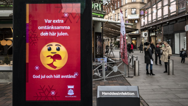 A public information sign wishes Merry Christmas and asks people to maintain social distancing in Helsingborg, southern Sweden.