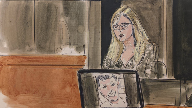 In this courtroom sketch, Annie Farmer testifies on the witness stand during the Ghislaine Maxwell sex abuse trial on Friday. A photo of Maxwell appears on a screen at foreground.