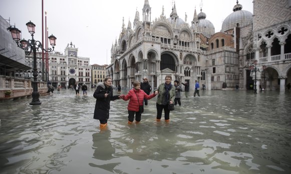 People wade through a flooded St Mark's Square in Venice, Italy, this week.