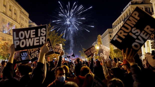 People shoot off fireworks in Black Lives Matter Plaza while celebrating president-elect Joe Biden's win over President Donald Trump.