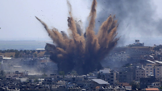 Smoke rises following an Israeli airstrike on a building in Gaza City on Thursday.