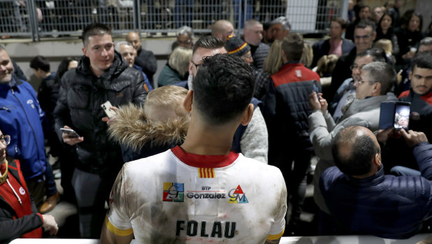 Folau poses with fans after the match.