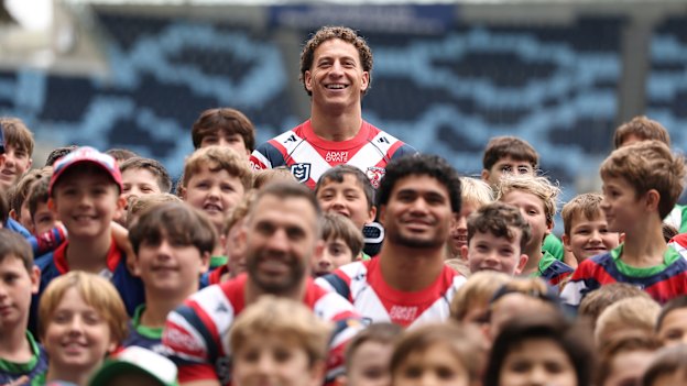 Mark Nawaqanitawase and Roosters teammates pose with juniors at Allianz Stadium. 