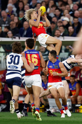 Kai Lohmann of the Lions takes a spectacular mark over Zach Guthrie.