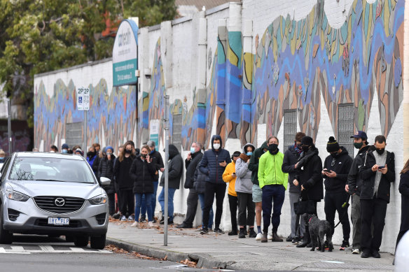 People wait to get a COVID-19 test in Collingwood. 