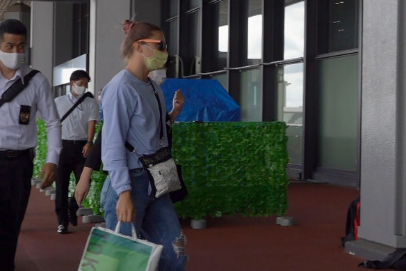 Belarusian Olympic sprinter Krystsina Tsimanouskaya, right, arrives at Narita International Airport in Narita, east of Tokyo, on Wednesday.