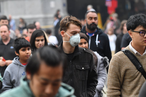 Melburnians don masks as the city is enveloped in haze.