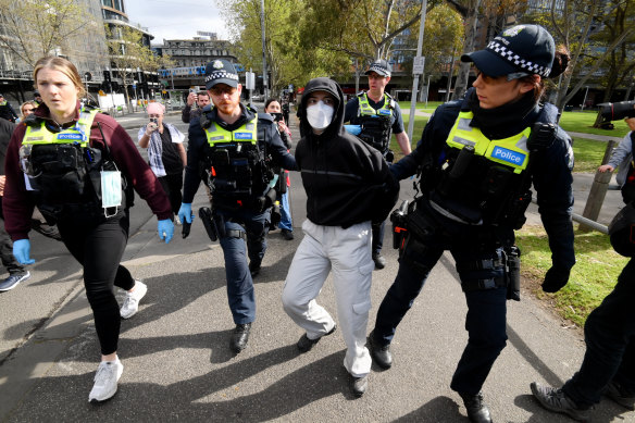 A protester is taken away near Batman Park on Friday, close to the weapons expo.