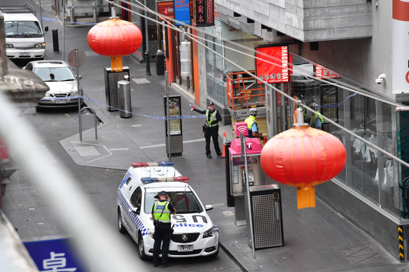 Police at the scene of the killing off Little Bourke Street.