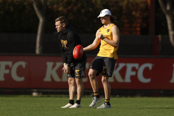 Jack Ginnivan alongside coach Sam Mitchell (left) at training on Tuesday.