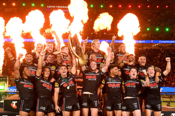 Panthers celebrate with the trophy after beating the Broncos for the 2023 NRL premiership.