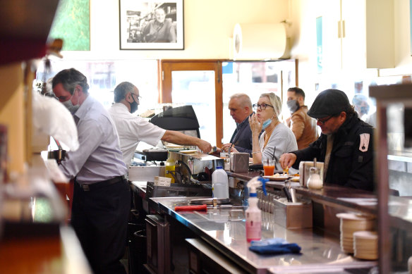 Customers eating at Pellegrini's Espresso Bar for the first time in months.