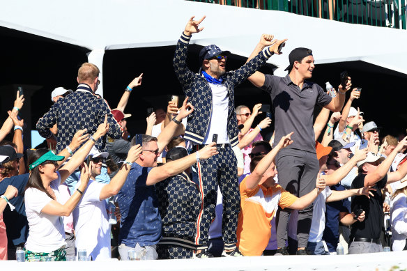 Fans cheer in the stands at the 16th.