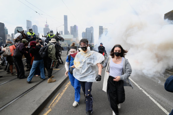 Masked protesters have been hit with pepper spray.