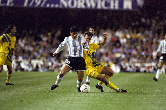 Diego Maradona beats Socceroo Jason van Blerk in a contest at the SFS.