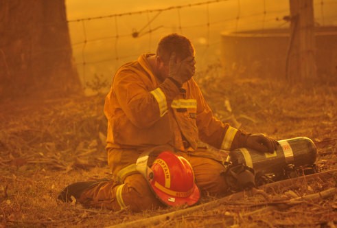 A firefighter reacts as a blaze rages out of control during the Black Saturday bushfires, which claimed 173 lives in 2009.