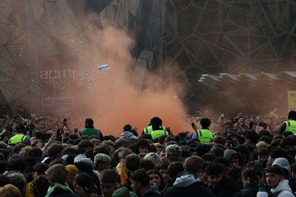 Impatient fans set off a flare at Federation Square before kick-off.