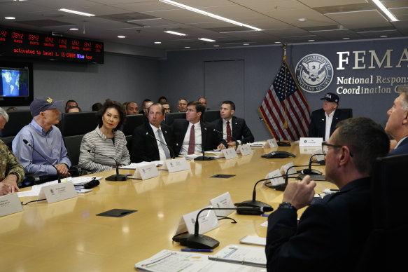 President Donald Trump, right, attends a a briefing about Hurricane Dorian at the Federal Emergency Management Agency on Sunday.