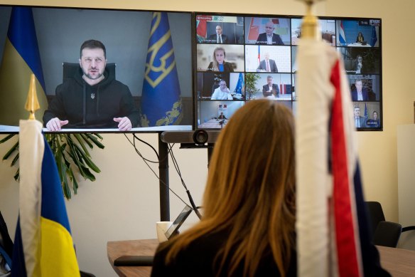 British sports minister Lucy Frazer listens to Ukrainian President Volodymyr Zelensky during meeting.