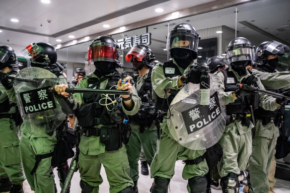 Riot police secure an area after detaining protesters in a shopping mall during a rally in Hong Kong, China. 