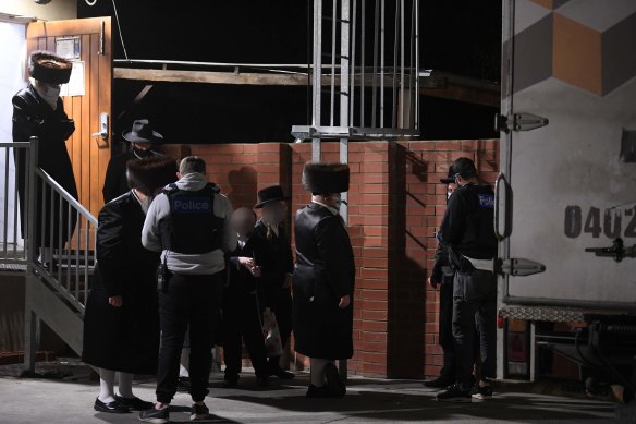 Police take details from people outside the synagogue on Tuesday night.