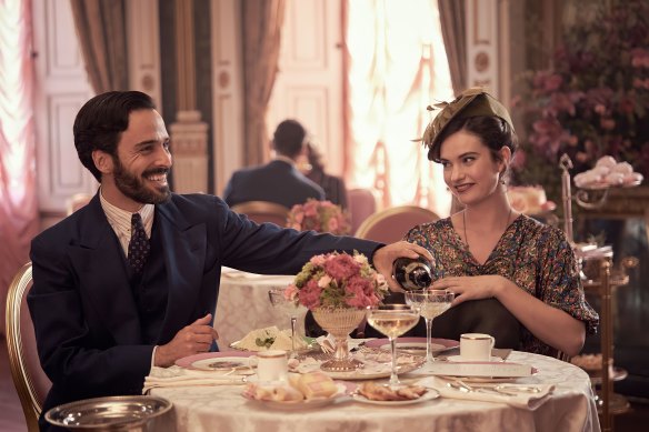 “Those ‘bright young things’ between the wars were really ‘out there’ people”: Fabrice De Sauveterre (Assaad Bouab) and Linda Radlett (Lily James) enjoy champagne.