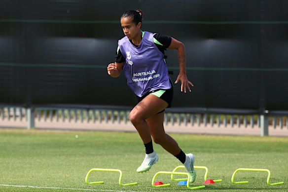 Mary Fowler warms up for Matildas training on Monday.