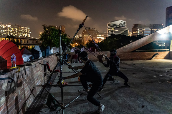 Protesters shoot with a catapult during a clash with police at the Hong Kong Poytechnic University on Saturday night.