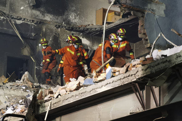 Firefighters look for victims in the aftermath of the explosion.