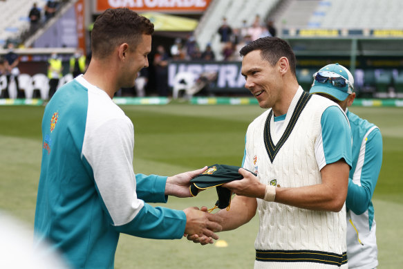 Scott Boland gets his baggy green cap from Josh Hazlewood before the third Test against England at the MCG in 2021.