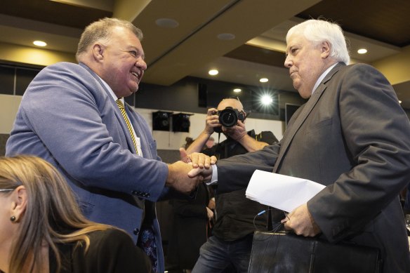 Craig Kelly shakes hands with Clive Palmer from the United Australia Party after his address to the National Press Club of Australia in Canberra on Thursday.
