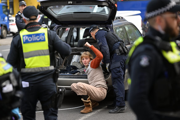 An anti-war protester had her arm in concrete in the back of a car on Kings Way on Friday.